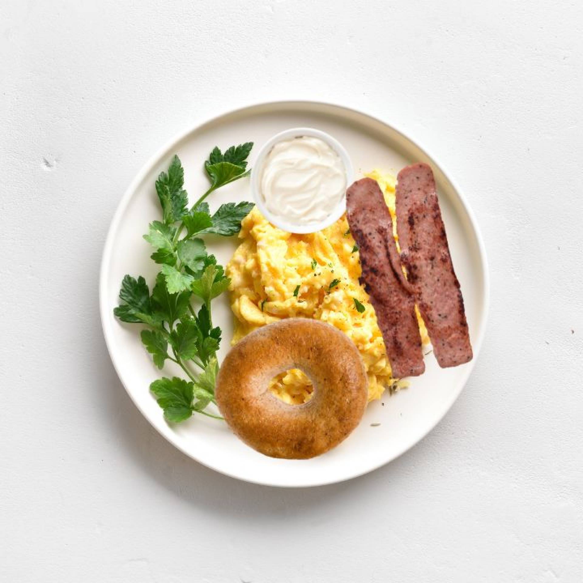 Hearty Breakfast Stack: Whole Wheat Bagel, Fluffy Scrambled Eggs and Crisp Turkey Bacon